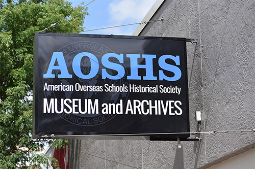 AOSHS Museum and Archives sign on exterior in daytime.