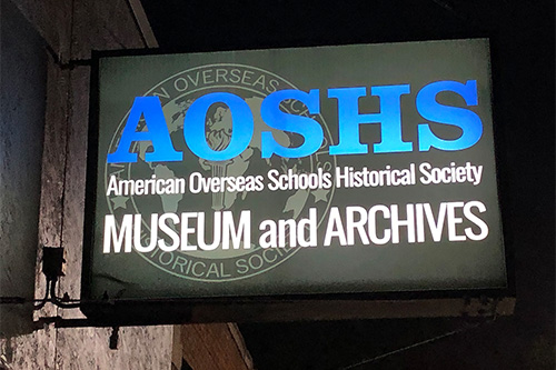 AOSHS museum and archives sign at night