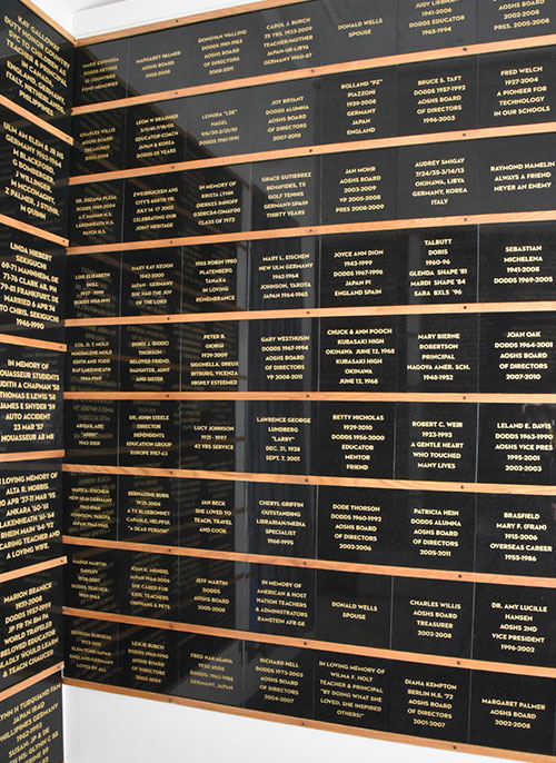 Medium, polished granite memorial tiles hanging on wall